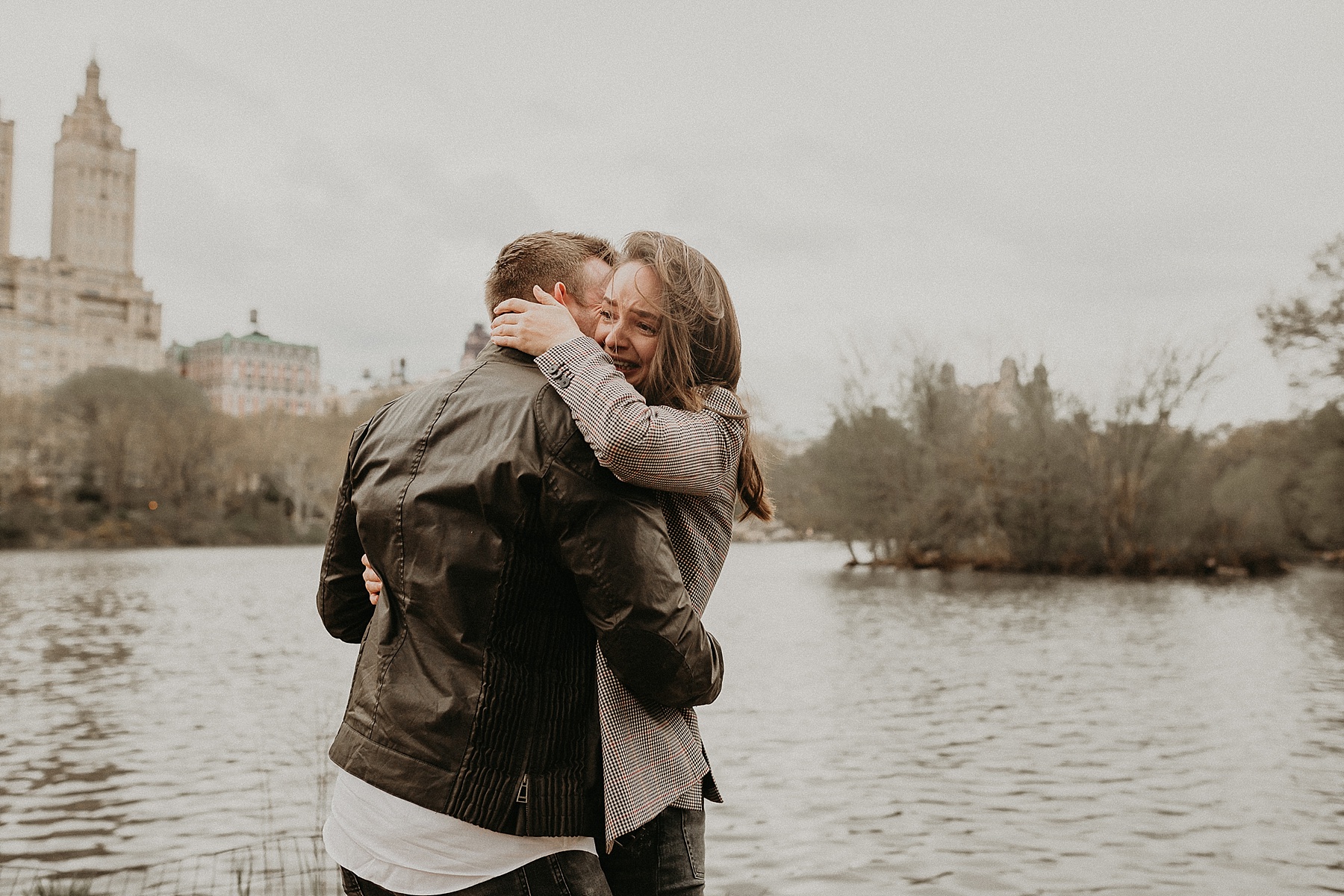 German girl looking happy and ecstatic as she says yes to accepting her German boyfriends surprise proposal in New York City's Central Park