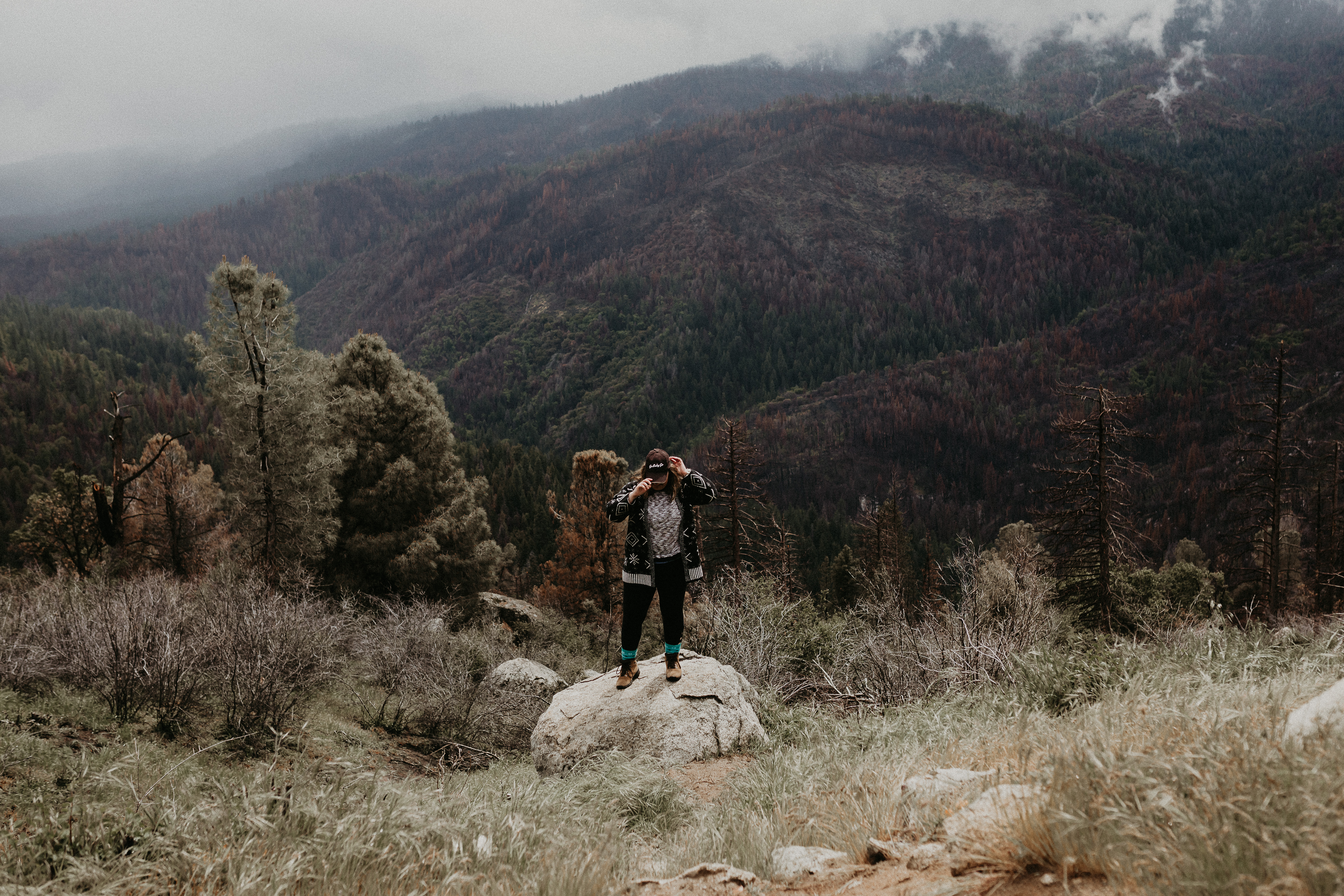 Yosemite Elopement Photographer standing on rock with Yosemite National Park in the background