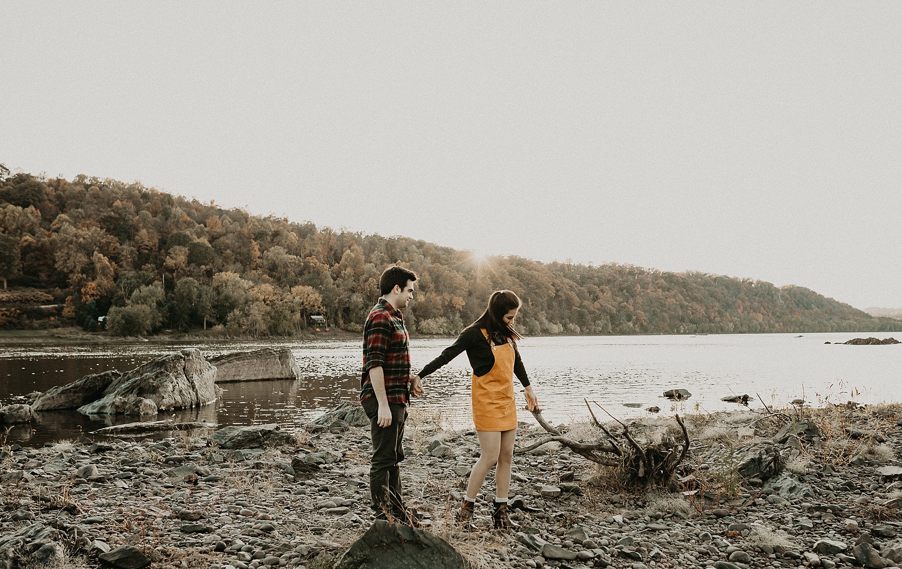 Engaged couple standing hand in hand as they walk along the Susquehanna River