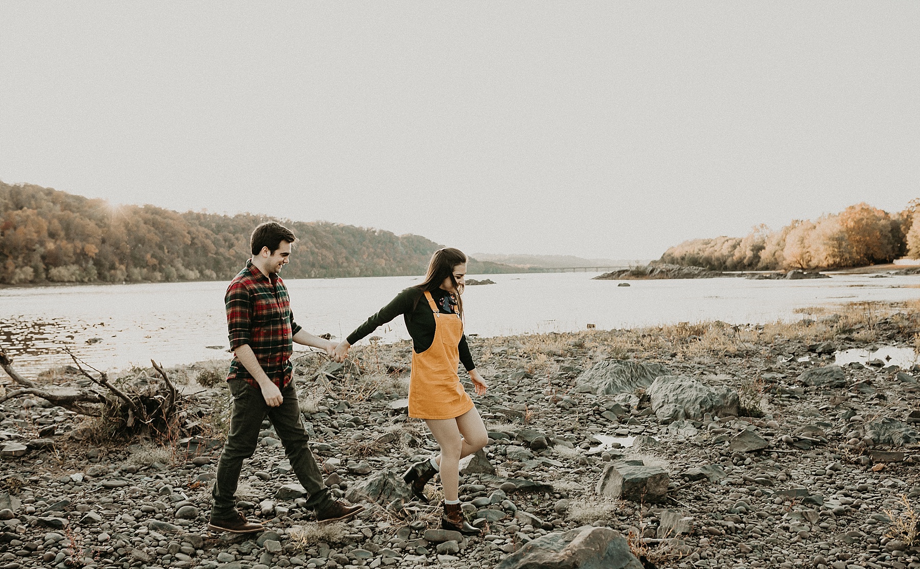 Engaged couple standing hand in hand as they walk along the Susquehanna River