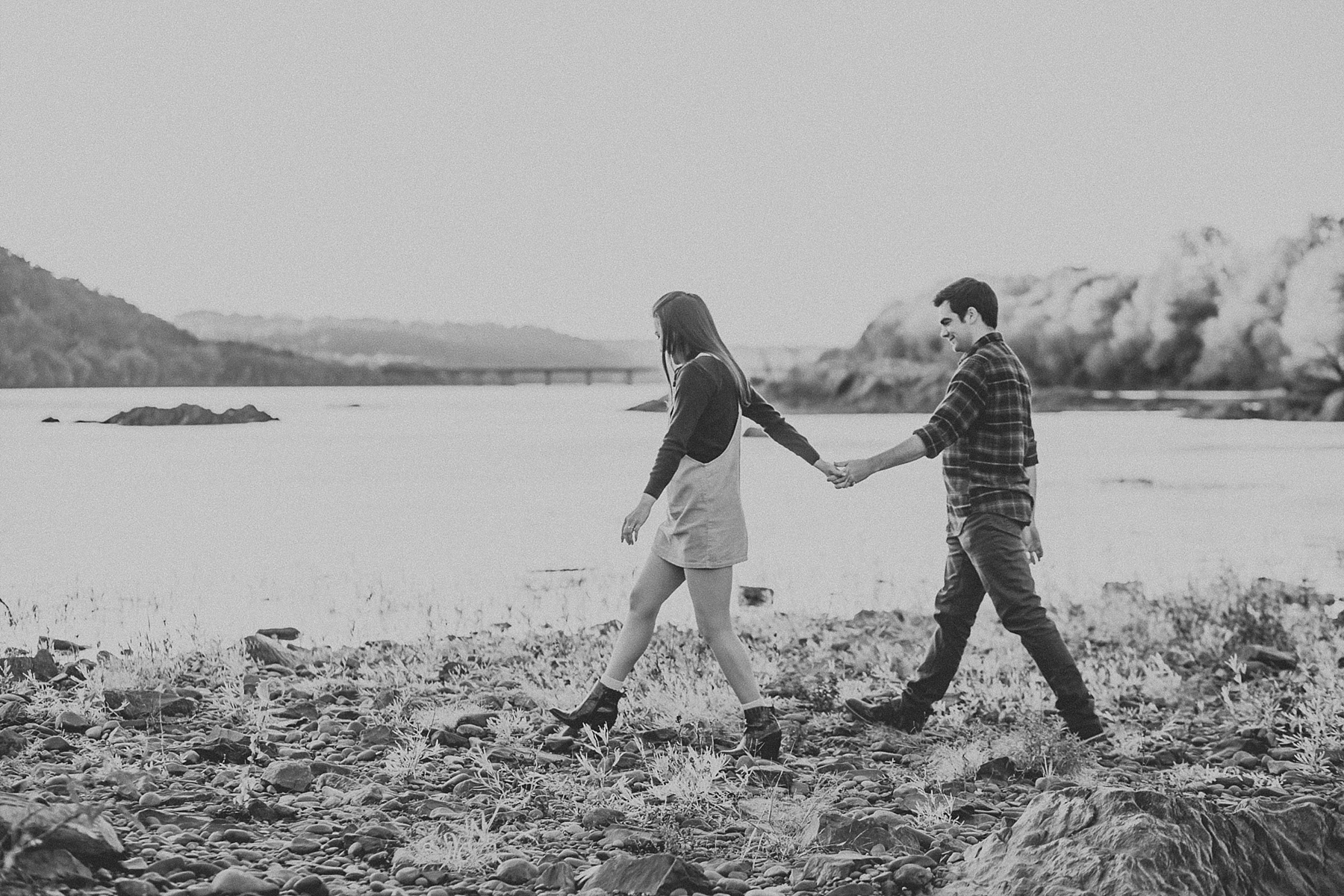 Engaged couple standing hand in hand as they walk along the Susquehanna River