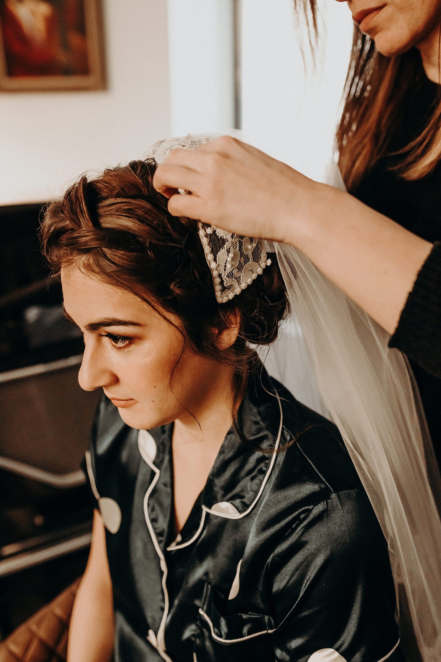 Vintage veil and cap being pinned into Brides hair