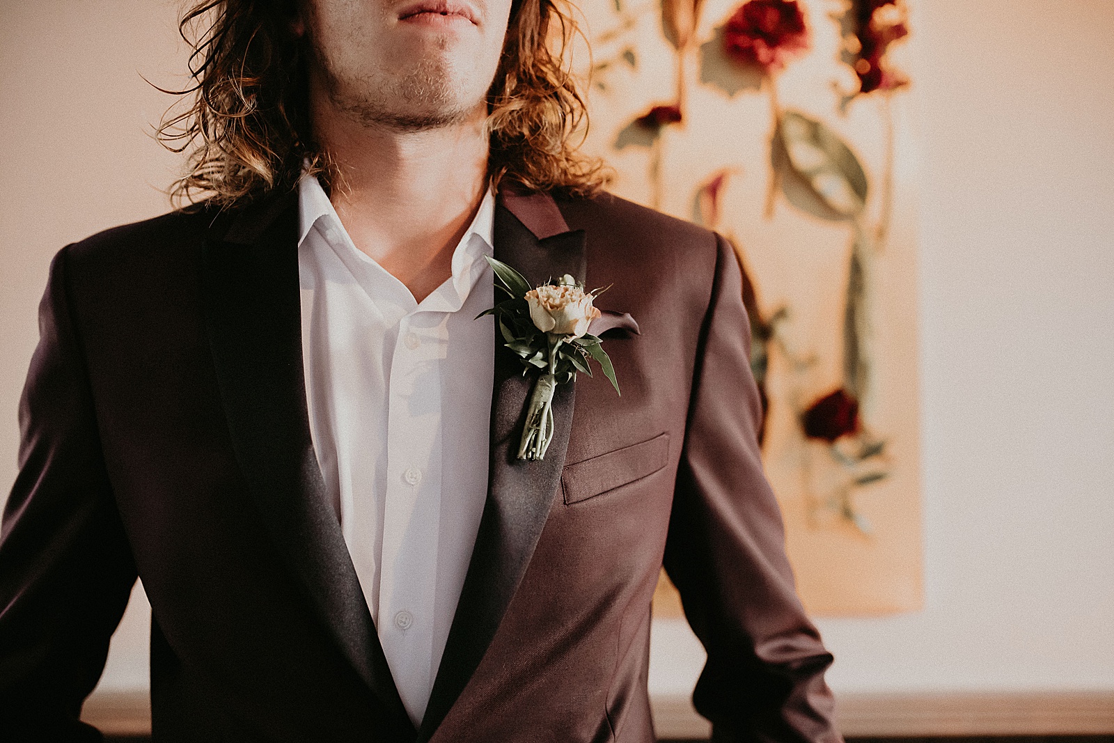 Groom boutonniere detail shot of cream colored roses