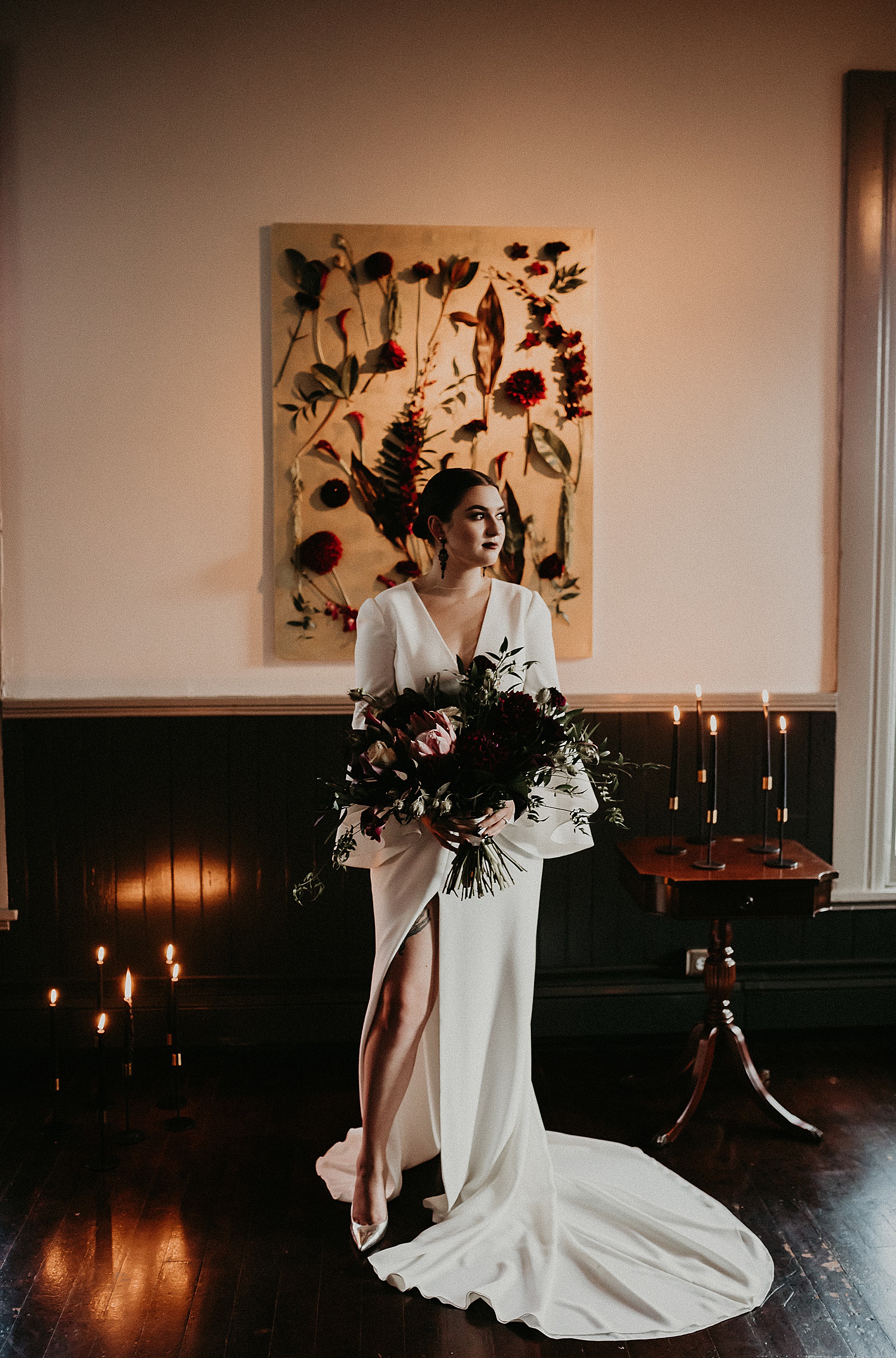 Dramatic dark and moody Bridal Portraits with oversized boho wedding bouquet in high slit wedding dress