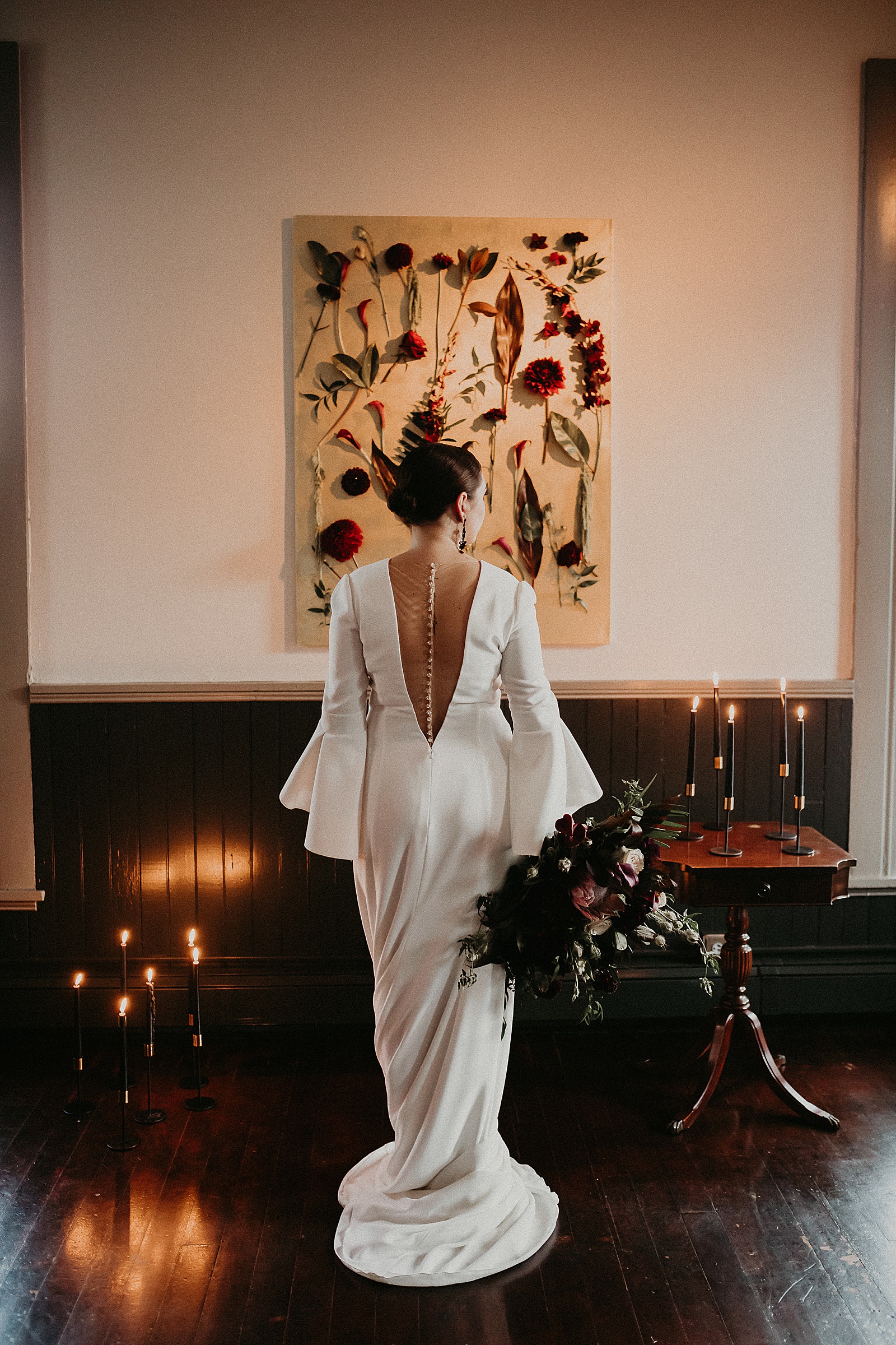 Dramatic dark and moody Bridal Portraits with oversized boho wedding bouquet in high slit wedding dress