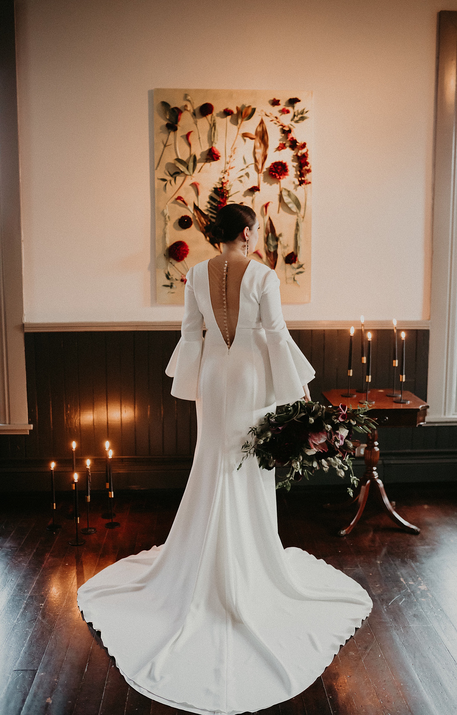 Dramatic dark and moody Bridal Portraits with oversized boho wedding bouquet in high slit wedding dress