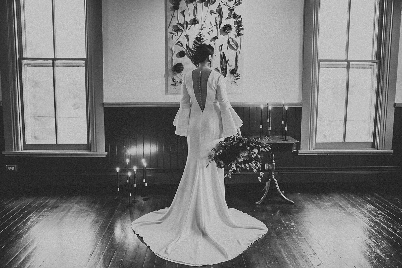 Dramatic dark and moody Bridal Portraits with oversized boho wedding bouquet in high slit wedding dress