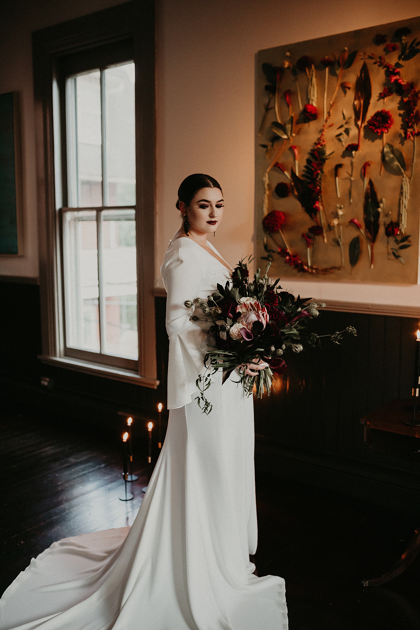 Dramatic dark and moody Bridal Portraits with oversized boho wedding bouquet in high slit wedding dress