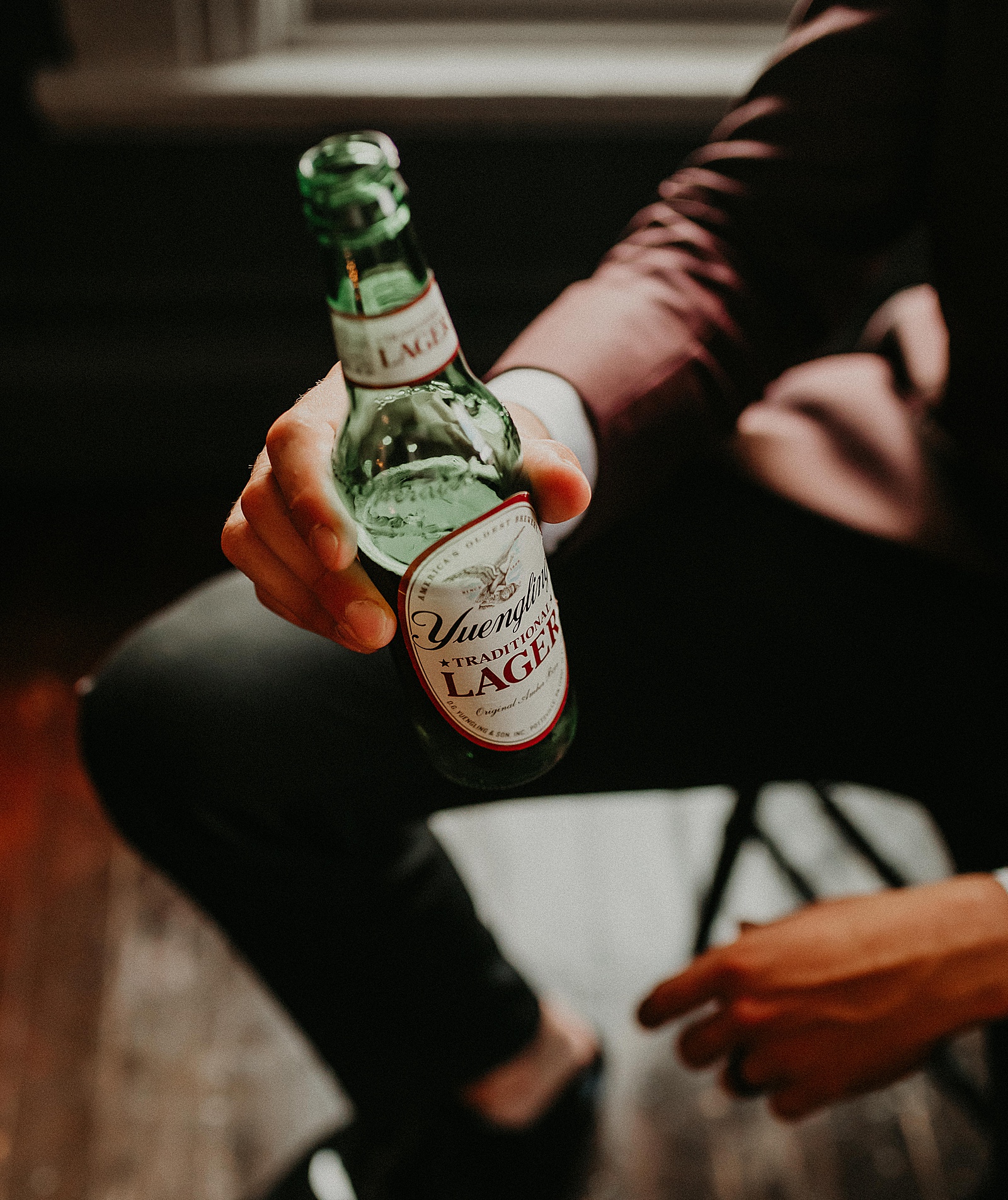 Groom sitting back and relaxing with a Yuengling beer