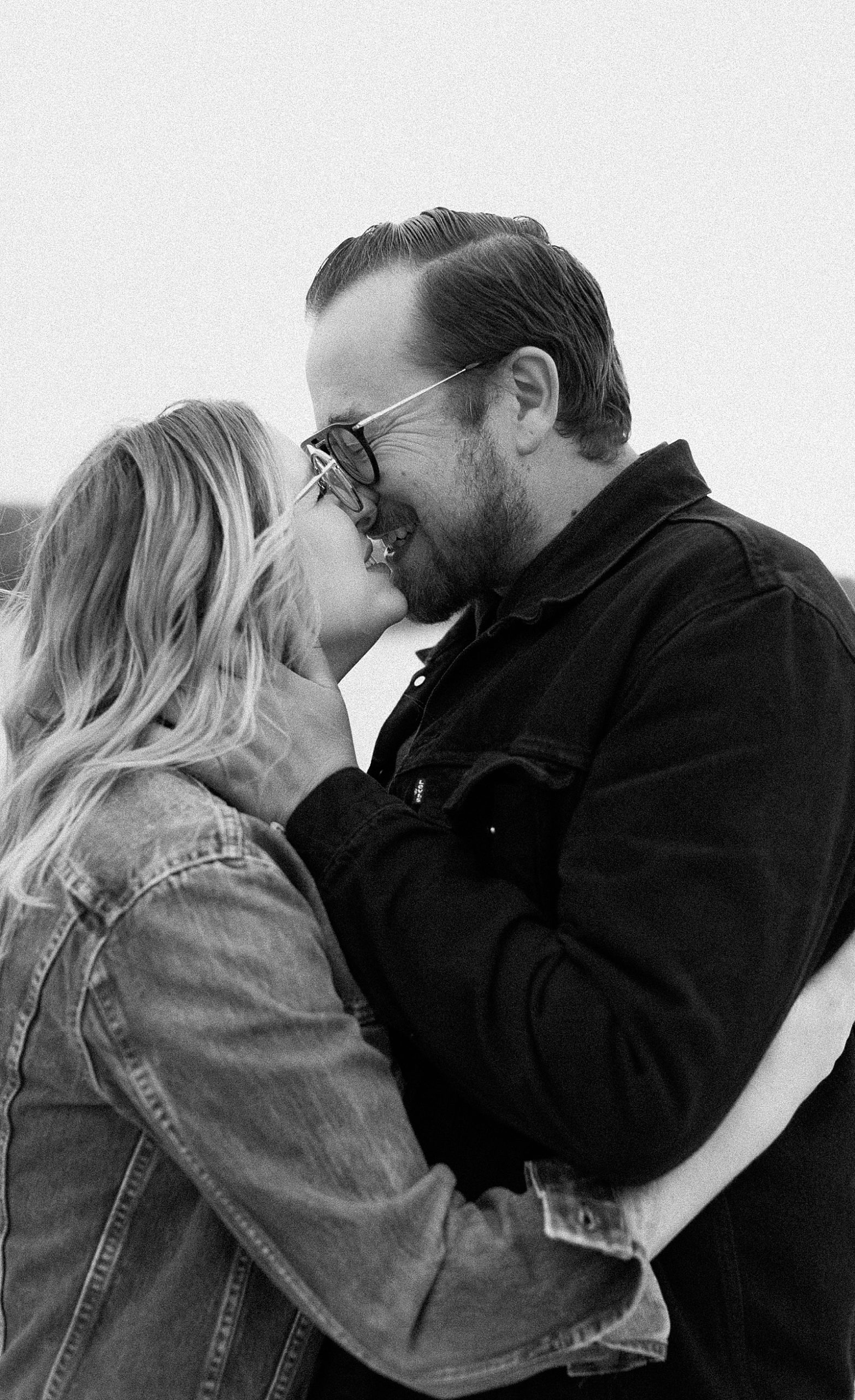 Couple snuggled up and smiling during couples adventure session at White Cliffs of Conoy